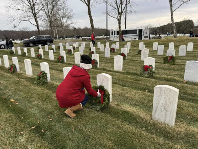 Congresswoman Hayes lies a wreath on the grave site of a fallen soldier 