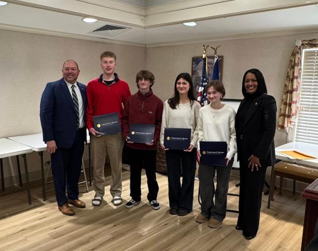 Congresswoman Hayes poses for a photo with students who were recognized with awards.